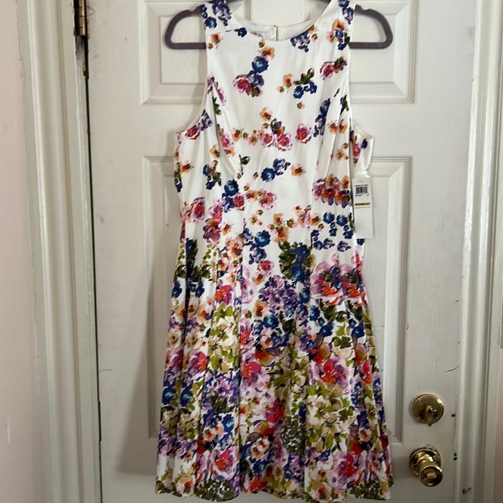 Maggie London - Party Dress.Tea length dress with slit pockets and under-ruffle.